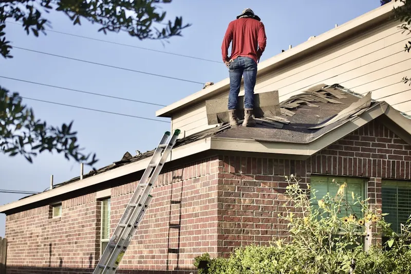 Professional roofer working on a residential roof in Molitor Estates